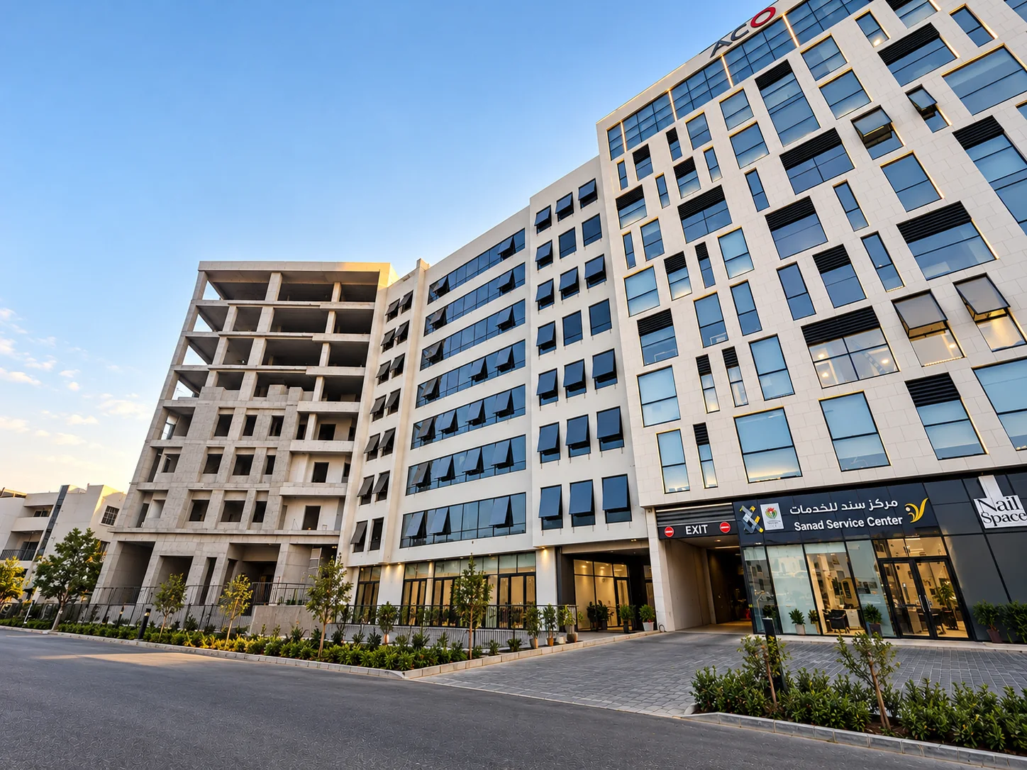 iTower building exterior viewed from the landscaped approach at golden hour