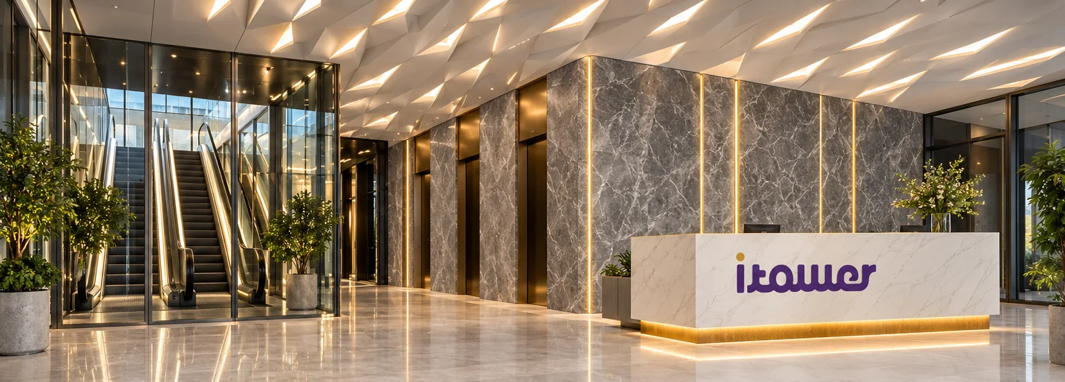 Contemporary reception lobby with warm lighting and a branded desk